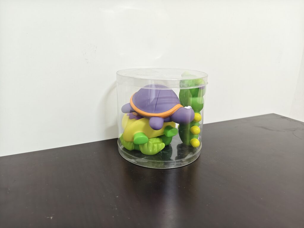 Round transparent toy packaging container made from PET